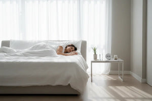 Person lying awake in bed at night, illustrating how poor sleep can disrupt hormones and slow fat loss progress 