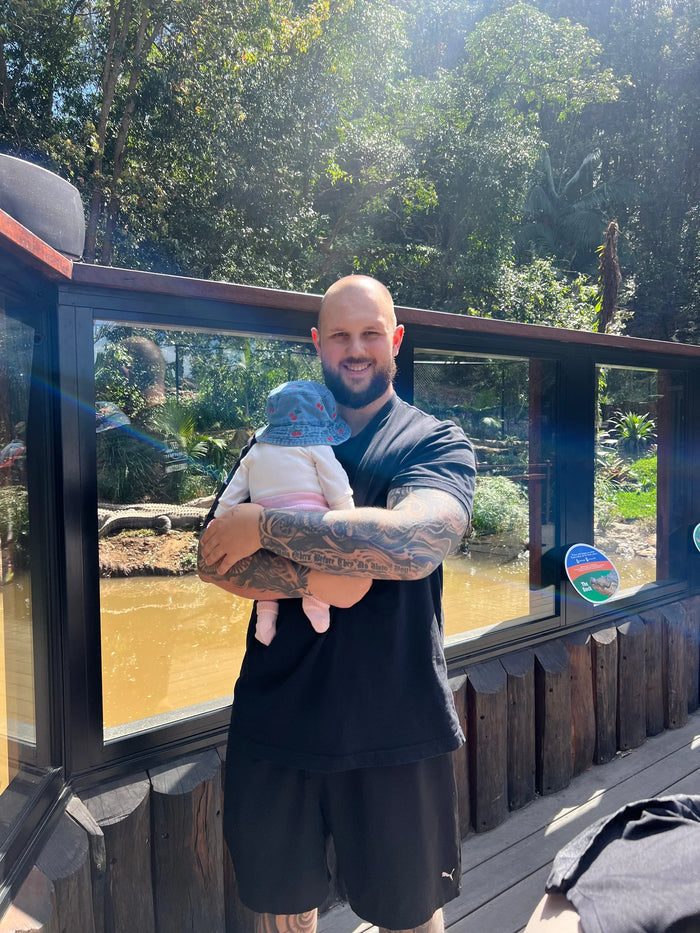 Jaydan Brennan 35kg down, holding his daughter